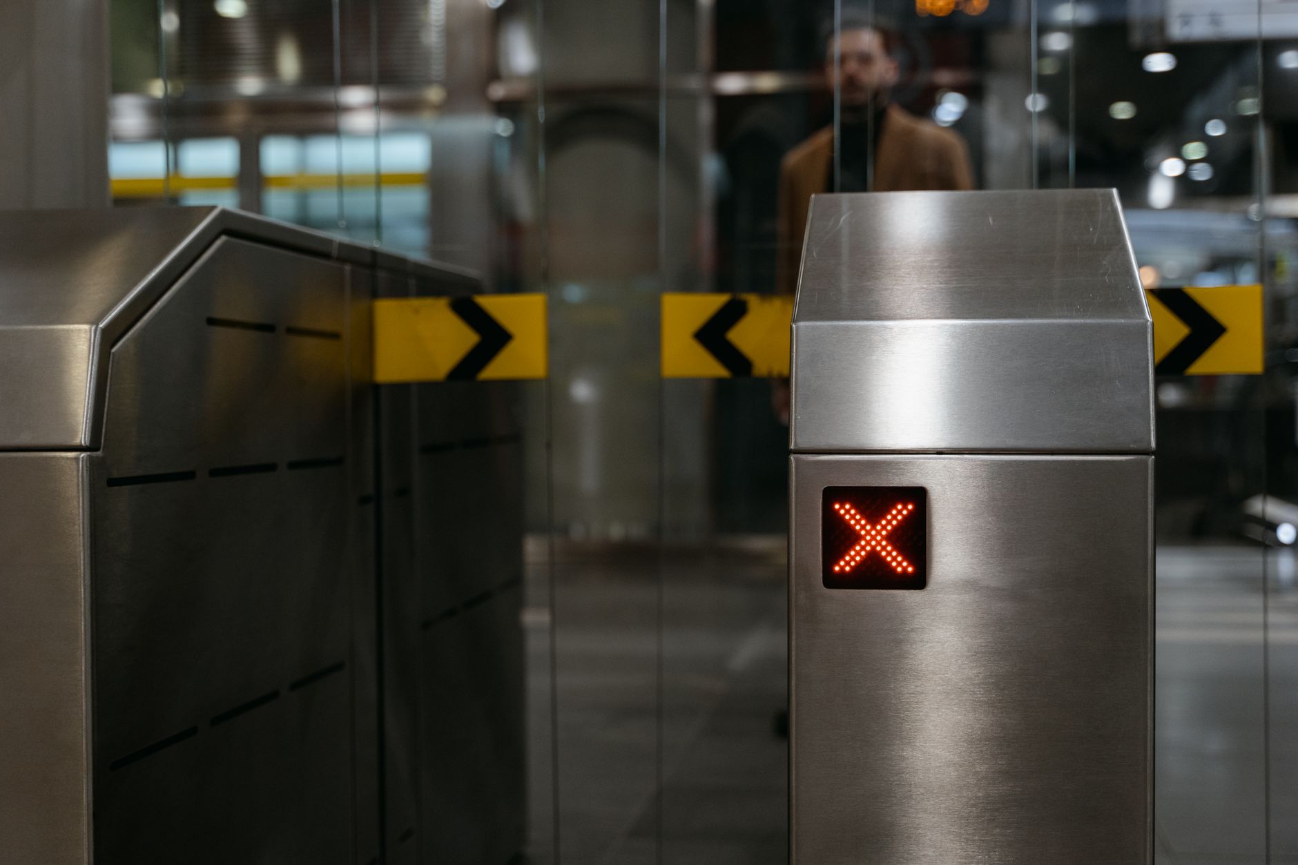 automatic entrance ticket gate at subway entrance with an led x sign